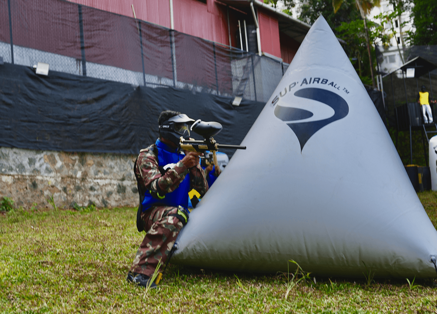Player diving behind cover with paint explosion